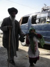 Afghanistan - Kunduz / Kondoz: a blind man is led by a child - photo by J.Marian
