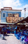 Albania / Shqiperia - Kor / Kora / Korce: selling carpets and rugs - bazaar scene - photo by M.Torres