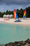 Maundays Bay, West End Village, Anguilla: white sand beach with turqoise water - mini-catamarans and beach gazebos - Cap Juluca five-star resort - photo by M.Torres