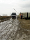Astara, Azerbaijan: Azeri-Iranian border - main vehicle border crossing - a muddy and litter strewn track alongside the beach - Mercedes-Benz truck clears customs - photo by F.MacLachlan