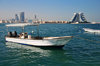 Muharraq Island, Bahrain: looking the the Manama skyline - twin outboard engine boat - photo by M.Torres
