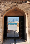 Arad, Muharraq Island, Bahrain: Arad Fort - view of the Al Manama skyline through the fort's main gate - photo by M.Torres
