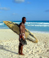 Barbados: surfer with board - photo by P.Baldwin