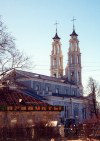 Belarus - Ashmjany / Oshmyany, Grodno / Hrodna voblast: Catholic church of St. Michael the Archangel and shop - material and spiritual - photo by M.Torres