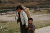 Bhutan - Kurjey Lhakhang - young boy with his mother - photo by A.Ferrari