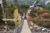 Bhutan - Kurjey Lhakhang - suspension bridge with prayer flags - photo by A.Ferrari