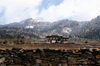 Bhutan - Ura valley - House and mountains covered with snow - photo by A.Ferrari