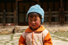 Bhutan - Ura village - Child outside the Geyden Lhakhang - photo by A.Ferrari