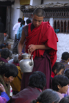 Bhutan, Paro: a monk distributes tea to pilgrims - photo by J.Pemberton
