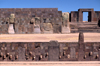 Tiwanaku / Tiahuanacu, Ingavi Province, La Paz Department, Bolivia: Semi-Underground Temple with carved enemy heads  Kalasasaya temple gate in the background - photo by C.Lovell
