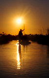 Okavango delta, North-West District, Botswana: Mokoro dugout canoe at sunset - punting - photo by C.Lovell