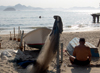 Rio de Janeiro, RJ, Brasil / Brazil: Copacabana beach - fisherman and nets near Copacabana Fort / pescador e artes de pesca junto ao Forte de Copacabana - photo by S.West