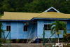 Bangar, Temburong District, Brunei Darussalam: blue wooden house and forest - photo by M.Torres