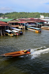 Bandar Seri Begawan, Brunei Darussalam: water taxi passing and water buses moored - Kampung Ayer water village - photo by M.Torres