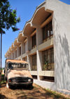 Gitega / Kitega, Burundi: government building and decaying old Portuguese UMM 4WD vehicle - Musinzira hill - quartier administratif - photo by M.Torres