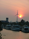 Toronto, Ontario, Canada / Kanada: the marina - sunset and wind turbine - wind generator - in the background Atlantis Pavilions and Liberty Grand hotel, ex-Ontario Government Building - photo by R.Grove