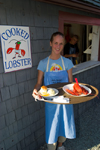 Canada 410 Waitress serving lobster at a restaurant in the fishing village of Halls Harbour, Nova Scotia, Canada. Model released. - photo by D.Smith