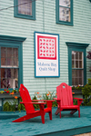Canada 453 View of the front porch with red chairs of the historic Mahone Bay quilt shop in Mahone Bay, Nova Scotia, Canada - photo by D.Smith
