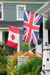 Canada 455 Close-up view of a Canadian and British flag at a home in historic Mahone Bay, Nova Scotia, Canada - photo by D.Smith