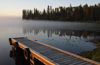 Canada / Kanada - Saskatchewan: reflection of trees and sky in this Northern Saskatchewan Lake - photo by M.Duffy
