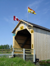 Adair, Carleton County, New Brunswick, Canada: Adair Covered Bridge - Canada and NB flags - Howe Truss - photo by G.Frysinger