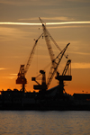 Barcelona, Catalonia: harbour cranes and red sky - photo by T.Marshall