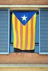 Barcelona, Catalonia: Catalonian flag on a window, in support of the independence of Catalonia - starred version of the flag, know in Catalan as the Senyera estelada, flown by separatists - photo by M.Torres