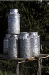 Chilo island, Los Lagos Region, Chile: milk cans await pick up on a country - dairy industry - photo by C.Lovell
