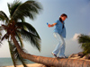 China - Hainan Island: gril walking on a coconut tree (photo by G.Friedman)