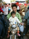 China - Hainan Island: father and daughter on motorcycle (photo by G.Friedman)