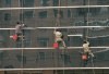 Beijing, China: hanging on - cleaning a glass faade - photo by M.Torres
