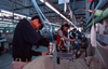 Dongguan, Guangdong province, China: ironing - Chinese factory workers - clothes factory - photo by B.Henry