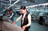 Dongguan, Guangdong province, China: Chinese factory workers ironing - textile factory - photo by B.Henry