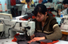 Dongguan, Guangdong province, China: seamstress using a sewing machine - Chinese factory worker - photo by B.Henry