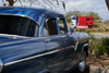 Santa Clara, Villa Clara province, Cuba: old American car and anti-American billboard - photo by A.Ferrari
