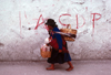 Ecuador - Quito: Indian woman with child and baskets  - street with CDP graffiti - photo by J.Fekete