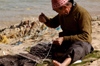 Egypt - Alexandria: fisherman mending nets (photo by John Wreford)