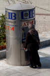 Egypt - Alexandria: muslim women using a cash machine / ATM (photo by John Wreford)