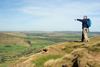 Peak District, Derbyshire, England: hiker pointing at the horizon - near Castleton - photo by I.Middleton
