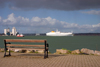 Hythe, New Forest, Hampshire, South East England, UK: promenade by the Southampton Water - bench and a UECC / United European Car Carriers ferry - photo by I.Middleton