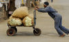 Eritrea - Asmara: a man pushing a heavily loaded hand cart - market area - photo by E.Petitalot