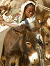 Eritrea - Senafe, Southern region: girl unloading her donkeys at the market - photo by E.Petitalot
