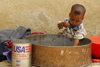 Eritrea - Mendefera, Southern region: toddler playing with water - photo by E.Petitalot
