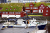 Trshavn, Streymoy island, Faroes: ferry M/F Ritan in the east harbour ready to go to Nlsoy - government buildings in Tinganes in the background - red buildings with green sod roofs - photo by A.Ferrari