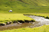 Elduvik village, Eysturoy island, Faroes: small house, stream and grass fields - photo by A.Ferrari