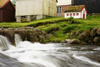 Gjgv village, Eysturoy island, Faroes: rapids and miniature house - photo by A.Ferrari