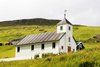 Elduvik village, Eysturoy island, Faroes: wooden church and green landscape - photo by A.Ferrari