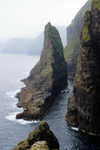Vgar island, Faroes: Geituskorardrangur - a towering basalt stack standing 116m above the ocean, by the vertical cliff face - photo by A.Ferrari