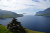 Srvgsfjrur fjord, Vgar island, Faroes: cairn on the cliff edge - photo by A.Ferrari