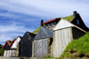 Leynar village, Streymoy island, Faroes: green roofed house and fishermen's huts - photo by A.Ferrari